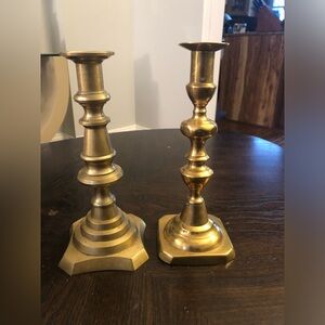 Two similar brass candlesticks
